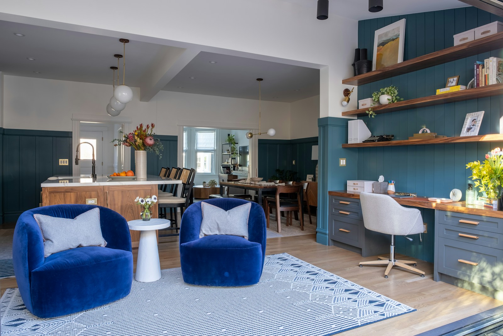 a living room filled with furniture and a dining room table